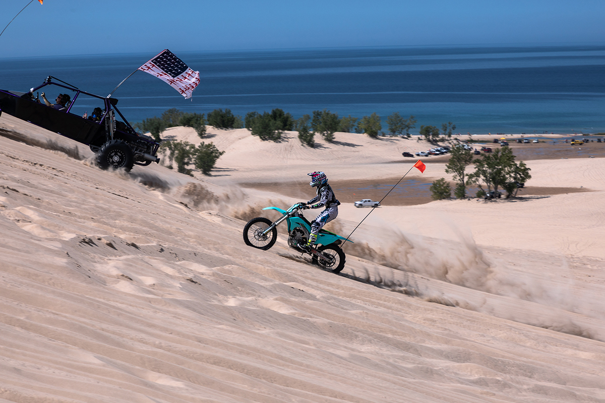 Dirt bike driving on sand dune