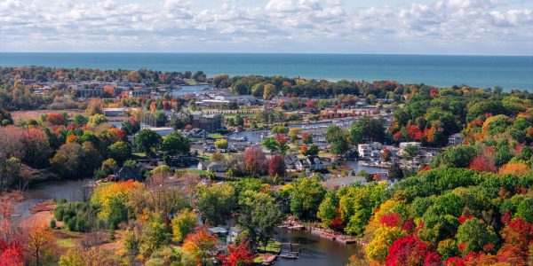 SHVB-October-series-16 Aerial photo of South Haven displaying fall colors in the trees with lake Michigan shining blue on the horizon.